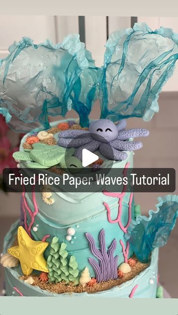 Dominique (Nika) Spencer, A Whisk Worth Tasting LLC on Instagram: "#tiptuesday 🌊 Fried Rice Paper Waves Tutorial!  Use spring roll wrappers/rice paper. I get mine from the Korean market but they are also available on Amazon and major grocery stores   💙 Soak them in a plate of water colored with gel color (I use @americolor sky blue) for about 3-5 mins until completely pliable.   Set them out on wrinkled parchment paper to dry for 24-48 hours. I wrap them around a toothpick while wet so I can easily stick them in my cake.   Once dry, fry them in hot vegetable oil and voila! 🌊   Will you try this?! Follow @whiskworthtasting for more cake decorating tips! * * * * * * * * #cakemaker #cakesofinstagram #caker #cakedecorating #caketips #cakeartist #edibleart #undertheseacake #onederthesea #hom Rice Paper Waves Cake, Rice Paper For Cake Decorating, Rice Paper Tutorial, Rice Paper Cake Decorations, Fried Rice Paper, Waves Cake, Paper Waves, Dolphin Birthday, Wave Cake