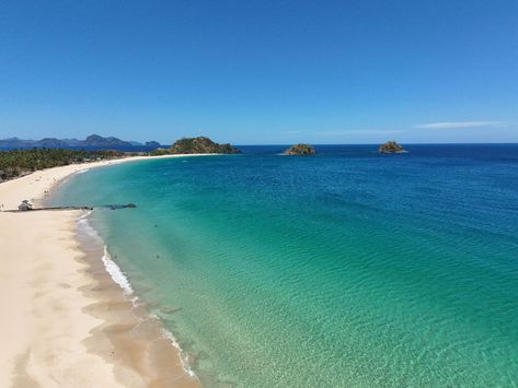 The long stretch of white sand at Nacpan Beach gleams brightly under the scorching sun, inviting you to bask in its radiant beauty. 🌴🌊☀️⛱️ 📷 @whygophilippines #whygophilippines #choosephilippines #palawan #ph #philippines #elnido #elnidopalawan #explore #drone #dronephotography #dronelife #condenasttraveller #NacpanBeach #nacpan Scorching Sun, Radiant Beauty, Conde Nast, Palawan, Drone Photography, White Sand, Philippines, Sun, White