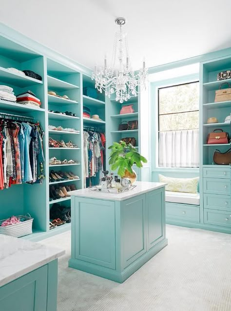 Turquoise blue walk-in closet features a window seat bench under a window surrounded by blue built-ins with glass knobs. Room Wardrobe, Closet Features, Contemporary Closet, Closet Island, Window Seat Design, Closet Vanity, Dressing Room Closet, Armoire Dressing, Walking Closet