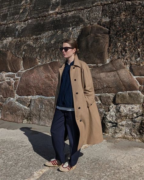 A woman stands against a dark wall. She wears a long camel coloured coat with navy trousers and jacket, and adidas x Wales Bonner trainers. Long Camel Coat Outfits, Coat Casual Outfit, Camel Winter Coat, Long Camel Coat, Camel Coat Outfit, Coat Inspiration, Adidas X Wales Bonner, Casual Winter Coat, Navy Trousers