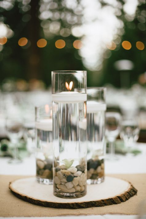 River Rock Centerpiece, Rocks And Candles Centerpiece, Beach Wedding Candle Centerpieces, Drift Wood Centerpiece Wedding, Candle Light Beach Wedding, Water Centerpieces, Floating Candles Wedding, Rustic Wedding Table Decor, Floating Candle Centerpieces