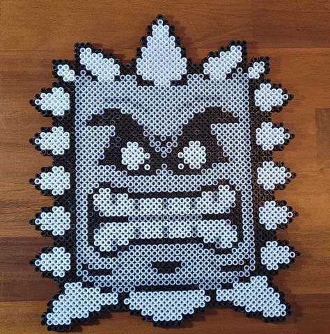 "Mario Thwomp made out of Perler Beads Size is 10.5\" x 9\" Hand made in Minnesota This item comes with tracked shipping. This unique wall décor can be hung as is, or mounted to a canvas, or framed for maximum aesthetic. Great conversation piece that will last for many years to come. This item is made by placing bead by bead, or pixel by pixel on a pegboard. The beads are then melted together by ironing one side together to create the finished product. Not seeing the design you like? Feel free to place a custom order!" Skeleton Perler Bead Patterns, Best Perler Bead Patterns, Nintendo Perler Beads, Perler Bead Bookmarks Pattern, Adult Perler Bead Patterns, Perler Bead Characters, Big Perler Bead Patterns, Nerdy Perler Beads, Mario Crafts