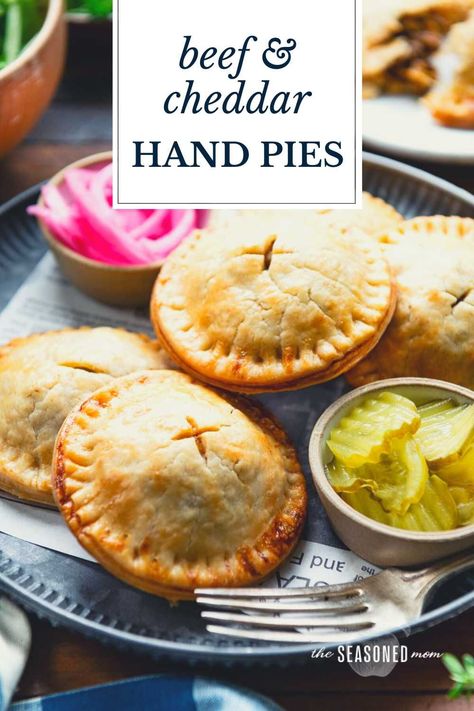 These easy meat pies include tender, buttery, flaky pastry dough wrapped around a flavorful ground beef, cheddar, and caramelized onion filling. Thanks to a couple of shortcuts, the convenient savory hand pies come together quickly and can be assembled in advance for busy weeknights! Easy Meat Pies, Savory Hand Pies Recipes, Savory Hand Pies, Beef And Cheddar, Hand Pies Savory, Meat Pie Recipe, Beef Pot Pies, Beef Pies, Hand Pie Recipes