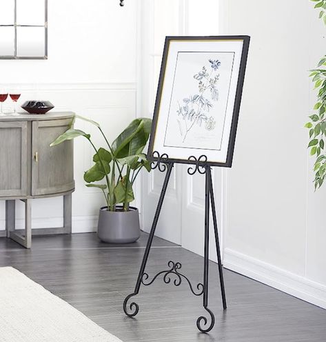 An elegant scrolled black stand to welcome your guests! Black Easel, Floor Easel, Scroll Bar, Show Art, Metal Easel, Black Living Room, Display Easel, Accessories Display, Artwork Display