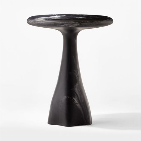 Sculptural side table from Caleb Zipperer updates the classic pedestal table with striking materiality and a modern biomorphic base. The organic silhouette is hand-poured and casted of matte black resin with swirls that resemble marble veining. Small in scale, marbled side table is the perfect accent to a lounge chair or sofa. CB2 exclusive.  -Designed by Caleb Zipperer -Cast marbleized black resin -Variation in activity of hand-poured resin is to be expected; each will be unique -Made in Vietna Sculptural Side Table, Resin Side Table, Black Round Table, Marbled Resin, Black Side Table, Black Resin, Pedestal Table, Entertainment Room, Marble Table