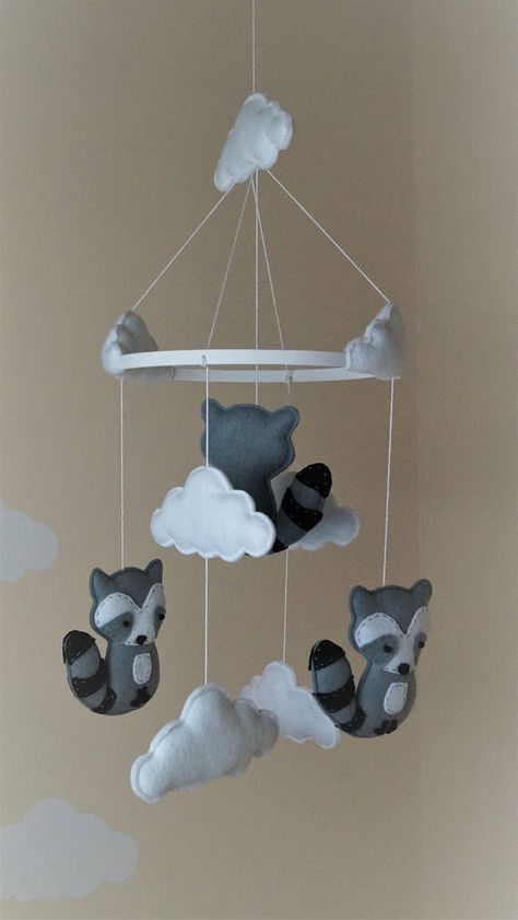 Baby raccoon nursery mobile with white clouds on a painted white 20cm hoop The mobile is lightweight and it can be hang from the ceiling or above cot bed. Size: Mobile full length: approx 50cm ******PLEASE NOTE THAT DUE TO SMALL PARTS AND THREAD THIS SHOULD ALWAYS BE KEPT WELL OUT OF Raccoon Nursery, Toddler Themes, Baby Raccoon, Cot Bed, Animal Crafts For Kids, Baby Crib Mobile, Nursery Mobile, Bed Size, Cot Bedding