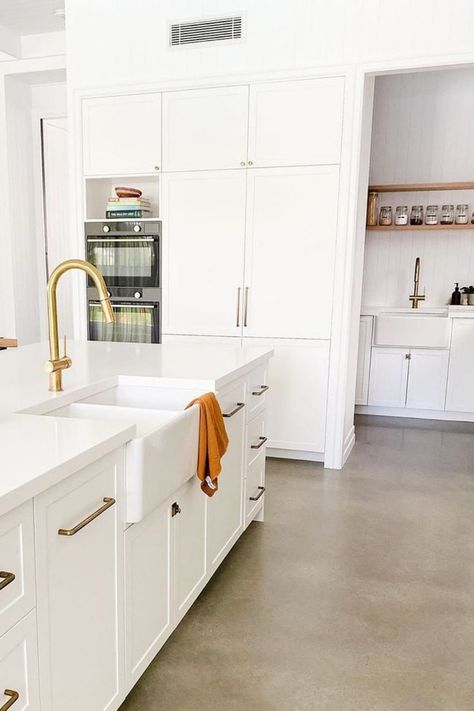 Modern kitchen with white cabinetry and polished concrete floors. Featured is also a butlers pantry with matching tapware and sink. Polished Concrete Floor Kitchen, Concrete Floors Bedroom, Concrete Floor Kitchen, Kitchen Concrete Floor, White Concrete Floors, Concrete Kitchen Floor, Polished Concrete Kitchen, Concrete Tile Floor, White Kitchen Appliances