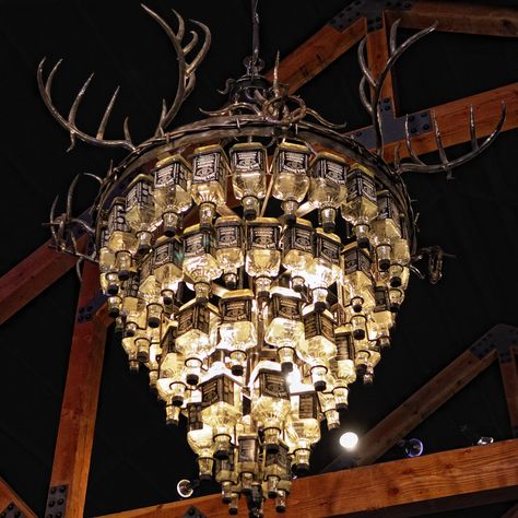 This amazing piece of contemporary art highlights the circular bar at the new dancehall/barbeque joint in Granbury – Rio Brazos Texas Music Hall. Glass Bottle Ideas, Bottle Chandelier, Jack Daniels Bottle, Bottle Ideas, Beer Bottles, Jack Daniel, Glass Bottle Crafts, Diy Bottle, Bottle Lights