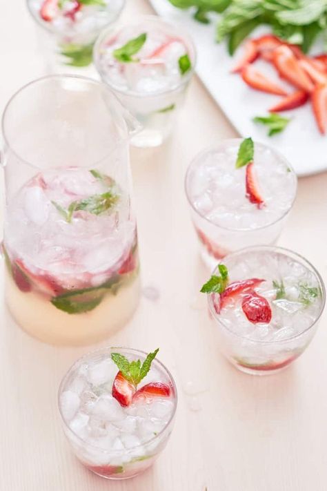 7 Pitcher Cocktails Perfect for Easter Brunch | Kitchn Strawberry Mojito Recipe Pitcher, Strawberry Mojito Pitcher, Easter Brunch Cocktails, Mojito Recipe Pitcher, Rum Drinks Easy, Mojito Pitcher, Strawberry Mojito Recipe, Frozen Strawberry Daiquiri, Pitcher Drinks