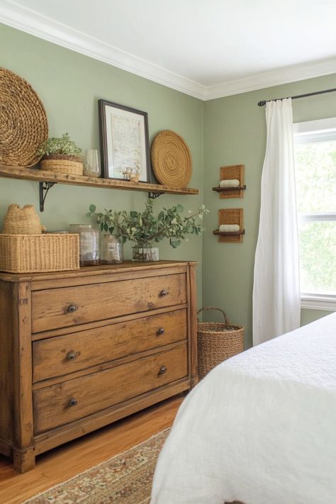 Get the perfect sage green farmhouse look in your bedroom using these quick tips and tricks. California Cool Bedroom Decor, Brown And Green House Decor, Sage Green With Dark Wood Bedroom, Green Country Bedroom Ideas, Forest Green Farmhouse Bedroom, Green Room Vibes, Natural Theme Bedroom, Neutral Sage Bedroom, Cottage Style Guest Bedroom