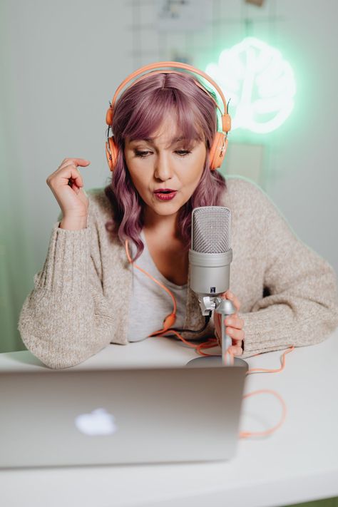 Young lady with light pink hair wearing orange headphones. She is recording into a podcast microphone that is connected to a laptop. Youtube Niche, Youtube Course, Youtube Analytics, 100 Dollars, Video Script, Youtube Ads, Starting A Podcast, Hustle Ideas, Branding Photoshoot