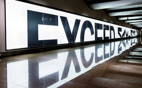 Clever Ad: Exceeding Limits | BMW asked German ad agency Serviceplan to develop a billboard that 'exceeds limits' at the Hamburg airport. Using a 50 x 2 m light wall in the middle of the arrivals hall, they designed a headline out of half letters. To complete the words, they used the reflection on the shiny floor. Hamburg Airport, Interaktives Design, Bmw M3 Coupe, Visuell Identitet, 광고 디자인, Environmental Graphic Design, Signage Wayfinding, Mirror Effect, Wayfinding Signage