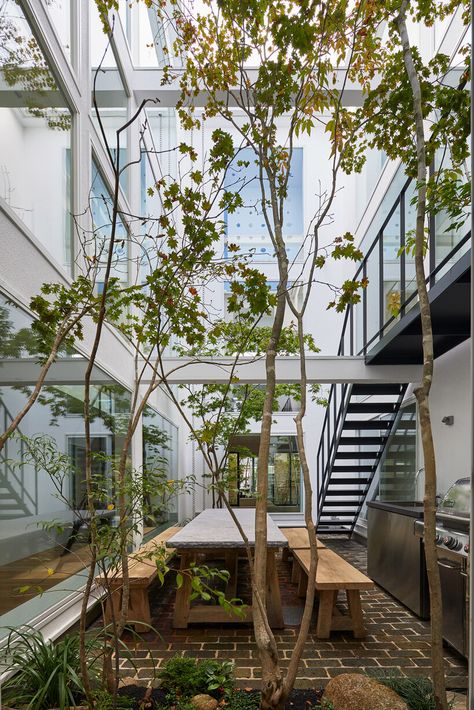 naf architect & design inserts glass courtyard in the center of tokyo house Two House Connected, Glass Courtyard, Tokyo House, Three Story House, Vertical City, Sustainable City, Architect Design House, Entrance Porch, Brick Flooring