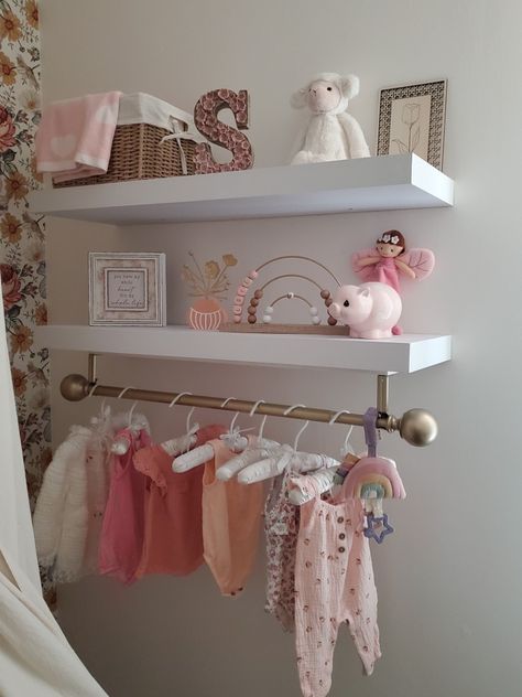 Creating a beautiful and functional nursery is an important part of preparing for a new baby. The shelves in this nursery provide ample space for decorative items and storage for baby essentials such as extras, toys, and blankets. The gold rod with cute clothing adds a touch of charm to the room while also serving a practical purpose. It's fun to regularly update the clothing on the rod. This is one of my favorite parts of the nursery! Floating Shelves Toddler Room, Nursery Shelves Decor, Nursery Shelving Ideas, Twin Baby Rooms, Nursery Shelf Decor, Nursery Shelf, Newborn Mom, Nursery Shelves, Baby Room Inspiration