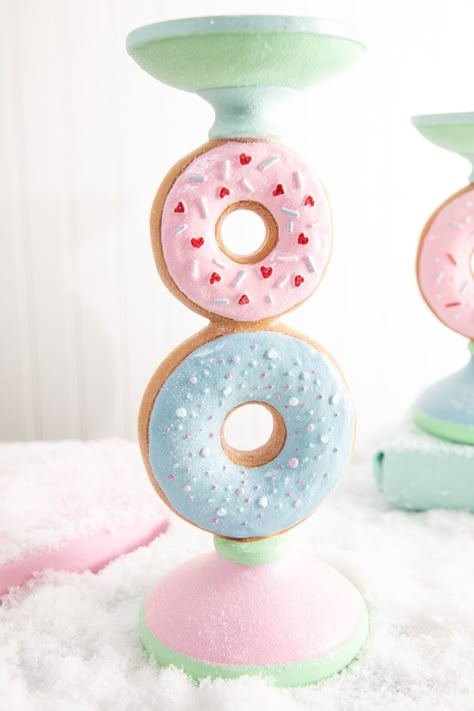 Discover the whimsical charm and functional beauty of our 11.5 Resin Donut Candle Holder. With its pastel blue and pink donuts stacked and adorned with realistic sprinkle detail, its sure to add a fun pop of color to your sweets Christmas decor. Beyond its aesthetic appeal, it also serves as a delightful home for your favorite candles, casting a warm and inviting glow for your cozy nights in. Donut Party Decor, Pastel Candy Christmas Decor Diy, Candy Room Ideas, Quirky Home Decor Ideas, Candy Bedroom Theme, Dessert Home Decor, Christmas Pastel Decor, Pastel Gingerbread Christmas Decor, Pastel Christmas Aesthetic