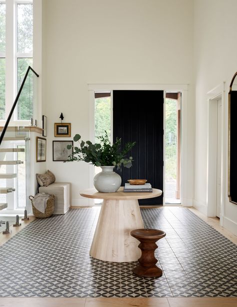 an entryway with a tiled floor section