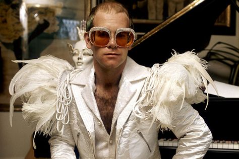 Photos: Elton John’s Outfits Through the Years – Rolling Stone Elton John Rocket Man, Elton John Costume, Robert Ryman, White Satin Fabric, Chris Roberts, Life Magazine Covers, Terry O Neill, Rocket Man, Jennifer Jones