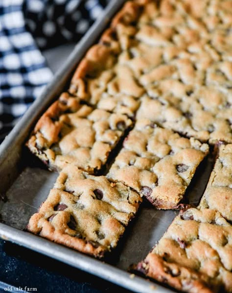 Rich and chewy sheet pan chocolate chip cookie bars have thick, crusty edges and a soft, chocolatey center. Easy to make and faster than traditional cookies! Picnic Food For A Crowd, Soft Chocolate Chip Cookie Bars, Sheet Pan Bars, Sheet Pan Cookies, Pan Bars, Chocolate Chip Pan Cookies, Easy Cookie Bars, Blondies Recipes, Work Treats