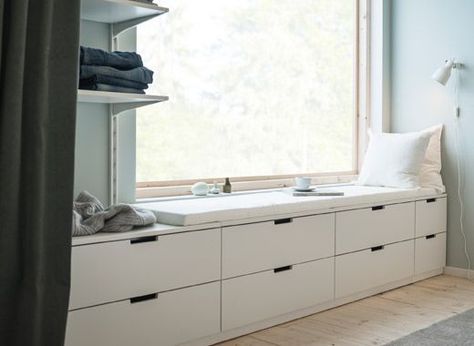 A wall with a window and a row of low bedroom storage made from modern, white chests of drawers Nordli Ikea, Ikea Hack Living Room, Bedroom Window Seat, Ikea Nordli, Bedroom Storage Chest, Soothing Bedroom, Design Ložnic, Ikea Drawers, Peaceful Bedroom