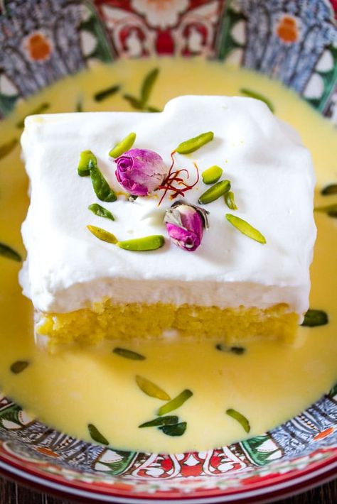 Saffron Milk Cake in a red bowl with rose buds and slivered pistachios Saffron Milk Cake, Milk Cake Recipe, Saffron Milk, Saffron Cake, Persian Desserts, Middle Eastern Desserts, Milk Cake, Tres Leches Cake, Indian Dessert Recipes