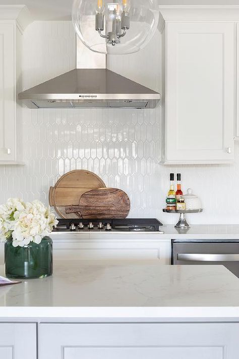 Glossy white picket tiles designed with white cabinets and white quartz countertop in transitional kitchen design. Kitchen Wall Tiles Ideas, Wall Tiles Ideas, Picket Tile, Organize Kitchen, Transitional Kitchen Design, Kitchens Ideas, White Kitchen Backsplash, White Tile Backsplash, Tiles Ideas