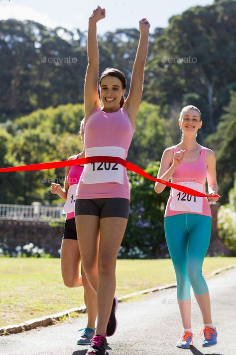 Cheerful winner athlete crossing finish line by Wavebreakmedia. Cheerful winner female athlete crossing finish line with arms raised in park #Sponsored #crossing, #finish, #athlete, #Cheerful Crossing Finish Line, Female Athlete, Running Track, Vision Board 2023, Poses Reference, Female Athletes, Finish Line, Media Marketing, Victorious