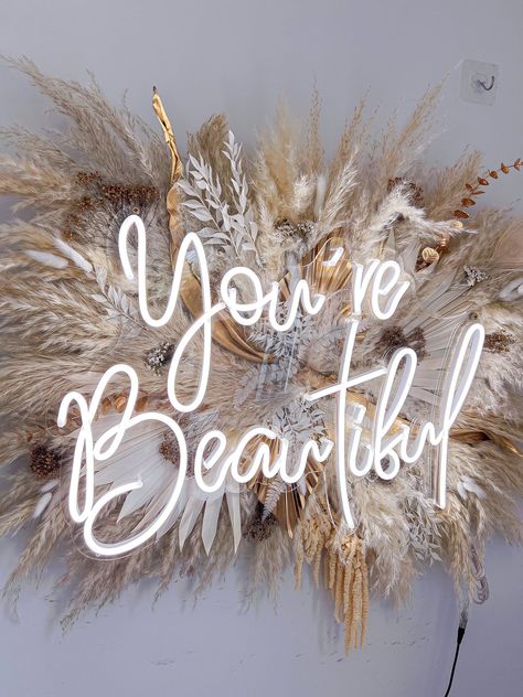 #WeddingNeonSigns #WeddingDecor #CustomNeonSigns #UniqueLighting Beauty Garden Salon, Salon Lights Ideas, Pampas Grass Wall Decor With Neon Sign, Pampas Grass Decor Wall, Beige Salon Decor, Boho Beauty Room, Salon Flower Decor, Pampas Sign, Boho Salon Suite Decor