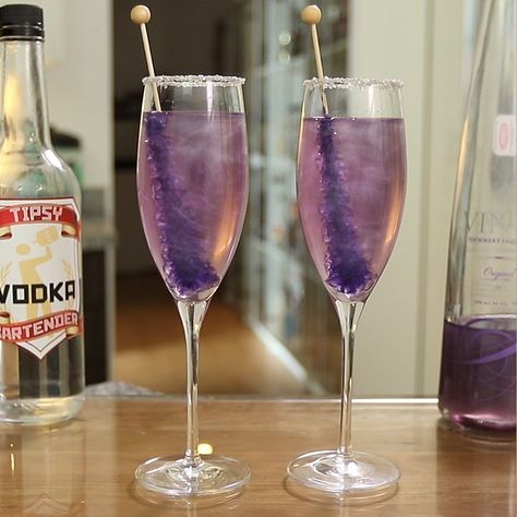 Make sure you have all the bartending tools you need to make these awesome drinks: https://www.amazon.com/shop/tipsybartender  Champagne cocktails don't get much prettier than this New Year's Purple Shimmering Champagne. This delicious 2019 New Year's Eve Champagne cocktail mixes up vodka, Purple Viniq, champagne, corn syrup, silver sugar, and Purple Rock Candy, and delivers sweet, bubbly tastiness with every sip. Vodka Mixers, Champagne Margaritas, New Year's Drinks, Champagne Recipes Cocktails, Champagne Punch, Purple Cocktails, Purple Drinks, Candy Cocktails, Champagne Drinks