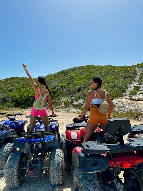 A picture of two girls wearing bright colorful workout sets sitting on ATVs at the beach. Atv Riding Outfit, Atv Riding Outfit Vacation, Quad Bike Aesthetic, Atv Riding Poses, Atv Insta Pics, Atv Ride Poses, Atv Riding Aesthetic, Atv Beach Aesthetic, Baddie Atv Riding