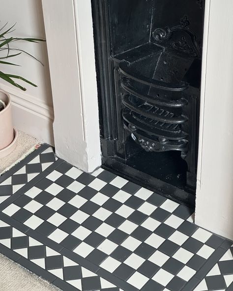 The third and final fireplace tiles (swipe to see previous attempts) When we first moved in the main bedroom fireplace didn’t have a hearth so I set about tiling it with some blue sunflower tiles. I instantly realised that it looked awful so after a few months I made Dan change them to the pink floral tiles… …but they still didn’t feel ‘right’ so now we have a Victorian black & white mosaic tile. They are classic but sometimes classic is best! (It’s been 5 years since we moved in and I a... Black And White Tiles Fireplace, Black And White Tiled Fireplace, Victorian Tiled Fireplace, Black Tiled Fireplace, Black And White Tile Fireplace, Fireplace Hearth Tiles, Victorian Fireplace Tiles, Hearth Tiles, Log Burner Living Room