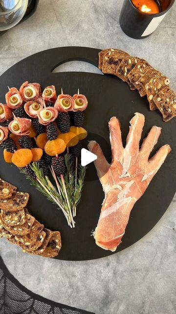 Ain’t Too Proud To Meg on Instagram: "#PromotionWithColumbusBrand SAVE this post & make a @columbusmeats SPOOKY HAND CHARCUTERIE for Halloween. @columbusmeats are my-go’s for serving up delicious, high-quality charcuterie and their Prosciutto and Italian Dry Salame are key to making this ghoulish spread. Full instructions ⬇️    INGREDIENTS  * 15.9 oz Gournay Garlic & Herb Cheese (or other soft cheese) * 3 oz @columbusmeats Prosciutto * 4 oz/22 slices @columbusmeats Italian Dry Salame * 3 oz/11 ciliegine * 1 oz/11 green olives stuffed with pimentos * 8 oz/20 blackberries * 4 oz/10 dried apricots * 5 sprigs rosemary * 4 oz crackers   SUPPLIES: plastic wrap & long toothpicks/skewers   INSTRUCTIONS: ⬇️   FOR THE HAND: 1. Line a bowl with plastic wrap and combine 10.6 ounces of herb cheese and Skull Brie Cheese, Hand Charcuterie Board Halloween, Halloween Skewers, Cheese Charcuterie Board Ideas, Halloween Crackers, Halloween Cheese Board, Spooky Charcuterie Board, Spooky Charcuterie, Halloween Charcuterie Board Ideas