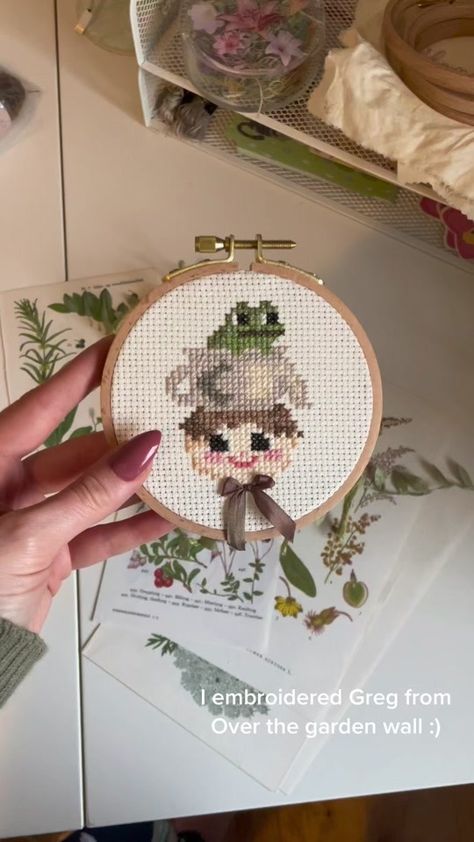 Cross stitch if Greg from Over the garden wall :) #overthegardenwall #... | TikTok Over The Garden Wall Crochet Pattern, Over The Garden Wall Embroidery Pattern, Over The Garden Wall Crochet, Over The Garden Wall Embroidery, Otgw Cross Stitch, Cross Stitch Patterns Over The Garden Wall, Over The Garden Wall Cross Stitch, Told In A Garden Cross Stitch, Embroidering Ideas