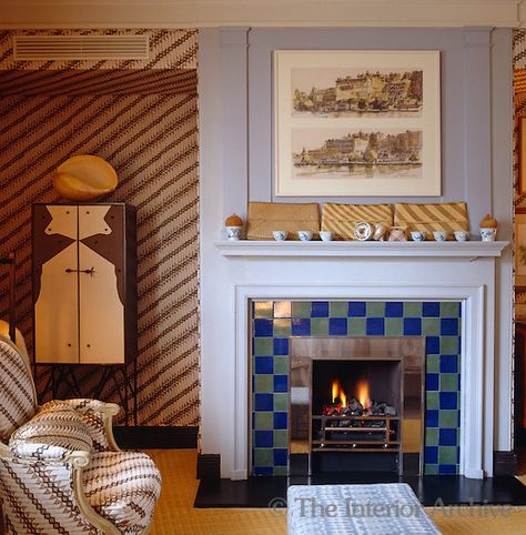 John Stefanidis ~ The bedroom is decorated with a collection of vintage Indonesian batiks which are used on the chairs and walls . Garouste & Bonetti metal cupboard Fireplace Cupboards, John Stefanidis, Metal Cupboard, Carnival Tent, Historic Interiors, Striped Bedroom, London Home, Fireplace Tile, Fireplace Design