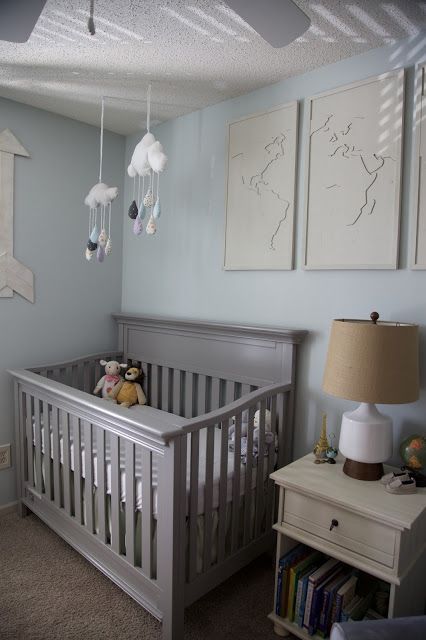 A travel and adventure-inspired gender neutral nursery with pops of burlap, pale gray, white, blue, and green. Light Blue Walls Nursery, Light Blue And Grey Nursery, Gender Neutral Nursery Grey Crib, Grey Crib Nursery Boy, Gray Crib Nursery Boy, Light Blue Boy Nursery, Nursery With Grey Crib, Light Blue Nursery Boy, Grey Crib Nursery