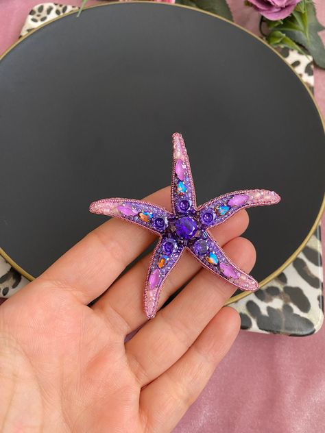 I made a wonderful purple pink energizing starfish brooch, which is my own design, for you.   I sewed high quality materials with love one by one.  This sparkling and bright gift purple pink starfish is a very special gift idea for your loved ones.  You can gift it to your wife,mom,friend,sister, girlfriend or yourself.  The crystal starfish will suit you or your loved ones very well.  You can use it especially as a beach and summer accessory.  It is a starfish pin that you can wear on your hat Purple Starfish, Pink Starfish, Beaded Starfish, Starfish Jewelry, Bright Gifts, Applique Tutorial, Tambour Embroidery, Mom Friend, Hand Painted Fabric