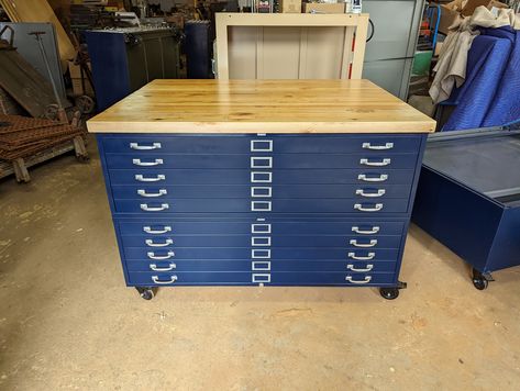 "Meet Big Blue.  Ten large Hamilton 48 x 36 drawer flat file cabinet set on heavy duty 4\" polyurethane swivel locking casters.  Done in Ink Blue.  Maple butcher block worktop 1-3/4\" thick.  Heavy,  did I mention Heavy.  Cabinet is 835 lbs.  Overall  size is 56in wide 41in deep 36in high.  Will ship in two parts.  To get this in, take out the drawers.  Then the case is big, but manageable.  If you happen to not like the blue.  We can do one for you in just about  any color you may like. PLEASE Flat File Desk, Filing Cabinet Ideas, Flat File Cabinet, Museum Storage, Tanker Desk, Literature Organizer, Maple Butcher Block, Flat File, Drawer Bins