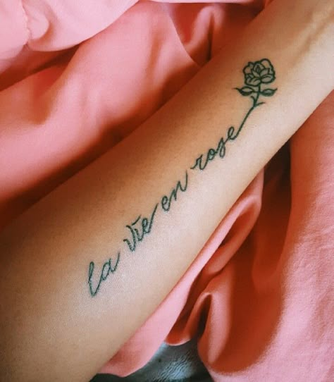 my first tattoo! la vie en rose @elysian.vibez La Vie En Rose Spine Tattoo, La Vie En Rose Tattoo Fonts, Cutesie Tattoos, Zia Tattoo, Tattoo Lettering Design, Skeleton Hand Tattoo, Flower Tattoo Sleeve, Tattoo Desings, Tattoo Font