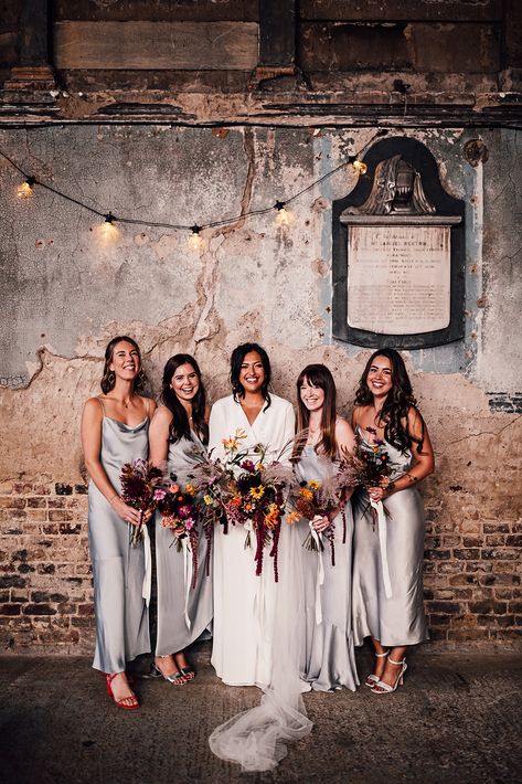 Bridal party in silver grey satin bridesmaid dresses with cowl neck with the bride in a long sleeve wedding dress with colourful wedding bouquet | wedding bouquet ideas | bridesmaid dress inspiration | Carrie Lavers Photography Silver Grey Bridesmaid Dresses, Gray Bridesmaid Dresses, Bridesmaid Dress Inspiration, Blue Bridesmaid Dresses Short, Wedding Bouquet Ideas, Colorful Wedding Bouquet, Silver Bridesmaid Dresses, Indian Bridesmaid Dresses, Bridesmaids Dress Inspiration