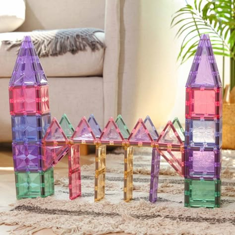 Our Premium Magnetic Tiles Pastel Building Set is the best way to nurture your child’s creativity by seamlessly combining fun and learning. OPEN-ENDED TOY The set comes with 108 different pieces that easily snap together making them great for building 2D and 3D shapes and structures fueled by your child's imagination. TEACHING TOOLS In addition to fostering creativity, our Magnetic Tiles Set helps children learn about geometry and science while also improving motor skills, logic, and color recog Toddler Toys Age 2-3, Magnatiles Castle, Magnetic Blocks Ideas, Magnatile Builds, Magna Tiles Ideas For Kids, Magnet Tiles Building Ideas, Magnatiles Ideas, Picasso Tiles, Magnetic Building Toys