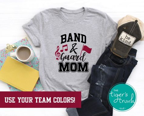 "Show your team spirit and pride with these adorable Band & Guard Mom shirts! These shirts can be personalized with your team colors. They make a perfect gift for your favorite Mom--or go ahead and treat yourself! *This is a unisex fit short-sleeve shirt. All of our shirts are made with high quality, durable vinyl that has been applied with a professional quality heat press. *Select your Shirt Size and Shirt Color in the Dropdown Menus. Use the photos labeled Shirt Color to pick your shirt color Color Guard Mom, Color Guard Shirts, Marching Band Gift, Marching Band Mom, Theater Director, Band Gifts, Theatre Shirts, Band Mom, Class Of 2025