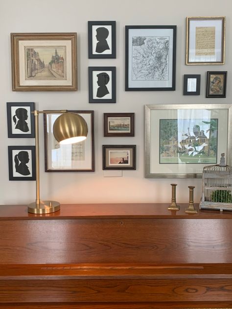 These silhouettes make a perfect addition to this gallery wall above our piano. Gallery Wall Above Piano, Above Piano Wall Decor, Piano Top Decor Ideas, Above Piano Decor, Piano Wall Decor, Piano Shelf, Dark Green Living Room, Top Decor Ideas, Piano Wall