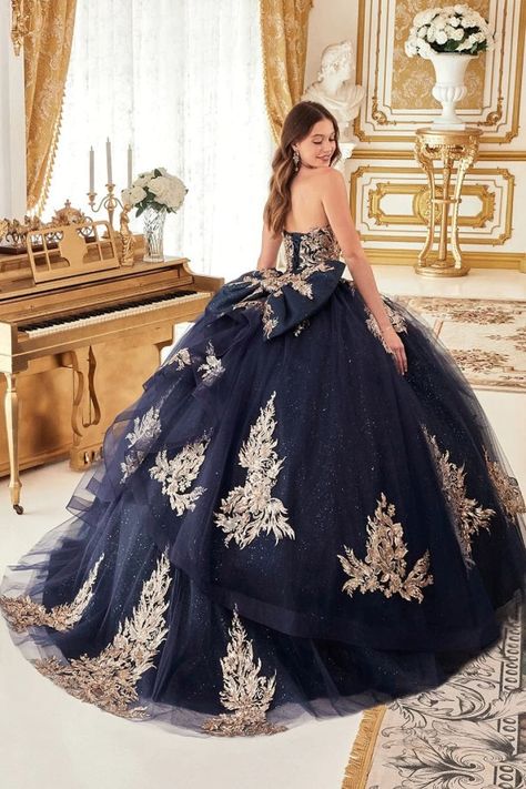 Captivate the room in the Ladivine Navy Gold Quinceañera Ball Gown 15715. This stunning strapless dress features a sweetheart neckline and a lace appliqué bodice, creating a timeless look for your special day. The full ball gown silhouette adds a regal touch, while the layered glitter tulle skirt gives your ensemble a mesmerizing sparkle. A beautiful giant bow at the back adds the perfect finishing touch, and the lace-up corset back enhances your figure, ensuring a flattering fit that highlights