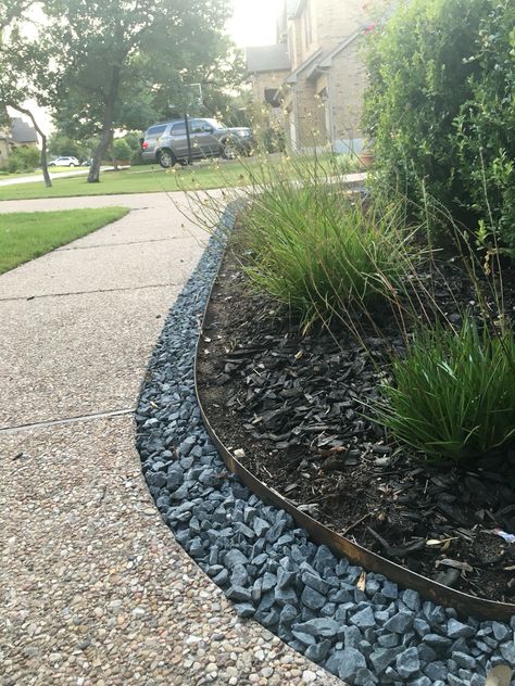 Grey colored rock border along flowerbed and sidewalk #stone #border Border Between Neighbors, Rock Borders Edging Sidewalk, Border Between Grass And Gravel, Stone Flower Bed Border, Stone Edged Flower Beds, Stone Edge Flower Bed, Chalk Art Sidewalk, Sidewalk Landscape, Sidewalk Chalk Ideas