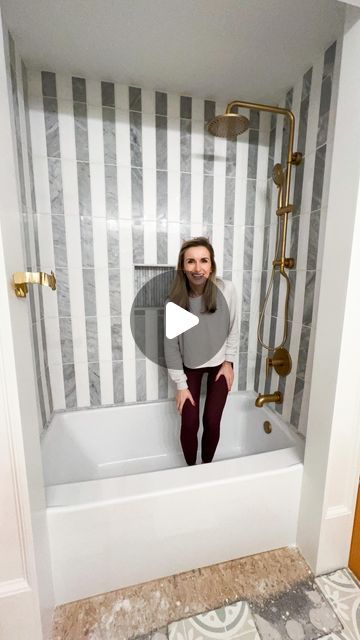 Lauren Jansen | DIY on Instagram: "The girls’ shower is FUNCTIONAL!!! Notice how I didn’t say done 😏 but the tile sure is and she’s a beaut!

I waterproofed with the Schluter System — it’s so user friendly! Then used Schluter’s AllSet Thinset to install my tile.

These are 3x12 white & carerra marble tiles from Floor & Decor. I did them in a striped pattern with 1/16” spacers. I wanted something classic and elevated but also something FUN since this is a kids bathroom.

The grout is unsanded eggshell Mapei grout, and I used 100% silicone caulk to seal everything!

I used marble 3/4” pencil trim in the niche for a fluted look and sealed between each piece of trim with clear silicone caulk to help even it out a bit.

I spray painted my existing fixtures Rustoleum champagne bronze and went o Schluter Niche, Herringbone Shower Tile, Herringbone Shower, Mapei Grout, Tile Shower Niche, Tennessee House, Silicone Caulk, Floor Trim, Champagne Bronze