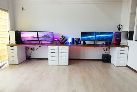 Gaming battlestation desk setup for couples. His and her gaming setup with wide desk and dual monitors // For more minimal gaming setups & battlestations, check out the Gridfiti blog // Photo by Unknown Gaming Desk For Two, Two Gaming Setups, Dual Computer Gaming Room, Double Gaming Desk Setup, Two Desk Gaming Setup, Computer Gaming Room Couples, Pc Setup For Couples, Gaming Room For 2 People, His And Hers Gaming Setup Desks