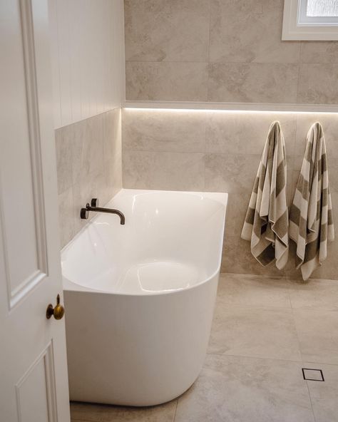 How incredible is this bathroom space by @NavyBoxConstructions?! Achieving the spa like feeling with the Posh Solus back-to-corner bath paired with the timeless white shaker style Kado Lux vanity. Contrasted by the Milli Pure tapware in brushed gunmetal with beige, textured tiles for a bright and inviting bathroom. 

Reece featured products 🛁 :
Milli Pure tapware, Milli Mood shower, Kado Lux vanity, Posh Solus back-to-corner freestanding bath. Shaker Style Bathroom Ideas, Brushed Gunmetal Bathroom, White Beige Bathroom, White And Beige Bathroom, Gunmetal Tapware, Beige Bathroom Tile, Inviting Bathroom, Textured Tiles, Main Bathroom Ideas