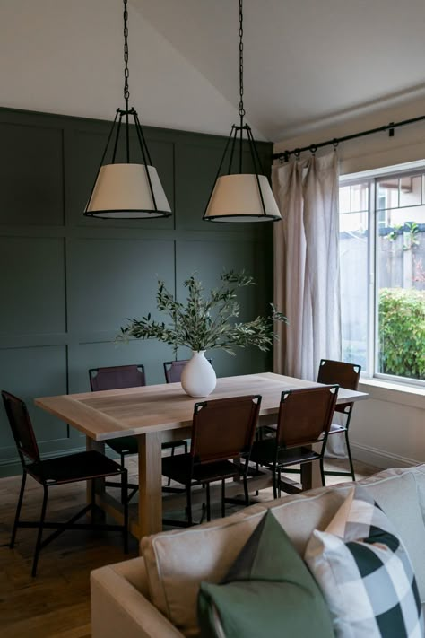 Dining room design + accent wall + green accent wall + wooden dining table + leather dining chairs + pendant lighting + open to living room + paneled wall | Light & Dwell | 29th Street Pt. 1  | Photo by Braevin Dining Room Accent Wall, Green Accent Walls, Green Dining Room, Dining Room Accents, Light And Dwell, Room Accent Wall, Living Room And Dining Room, Living Room Green, Dining Room Inspiration