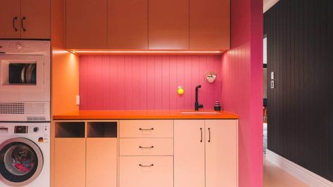 Step away from the white and grey: The housing market doesn't have to kill off bold design | Stuff.co.nz Vibrant Laundry Room, Colourful Laundry Room, Colourful Laundry, Retro Laundry Room, White Facade, Pink Laundry Rooms, Orange Floor, Laundry Room Colors, Living And Kitchen