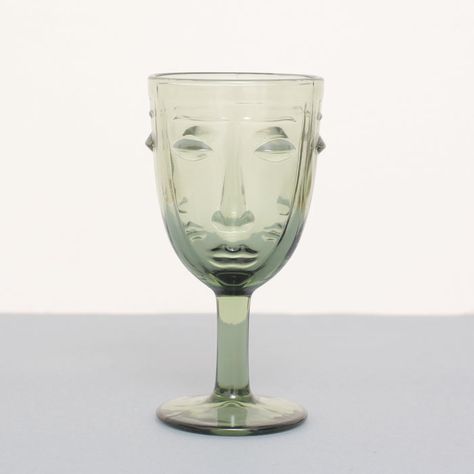 Add a pop of colour and style with the Deco Face Teal Wine Glass from McGowan & Rutherford. The light green glass wine glass is in traditional shape adorned with an art deco face. This quirky wine glass is sure to stand out against any table setting and will impress your dinner guests. Size : 16.5 cm x 8.4 cm Material : Glass Green Glasses Table Setting, Glass Vase With Face, Vase Styling, Green Vintage Glasses Boopie Table Setting, Dining Room Essentials, 70s Glassware, Kitchen Decor Inspiration, Stylish Dining Room, Vintage Green Glass Overstock