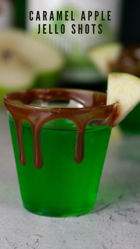 These caramel apple jello shots are perfect for fall and Halloween! They are made with green apple gelatin and sour apple schnapps for all the delicious green apple flavor. Caramel vodka is also added in to make the classic caramel apple. I like to put a caramel drip rim on the shot glass as well as a small slice of fresh Granny Smith apple! Find this Halloween jello shot recipe on my blog! Candy Apple Shots, Espresso Jello Shots, Caramel Apple Jell-o Shots, Caramel Apple Jello Shots, Apple Jello Shots, Caramel Apple Shots, Green Apple Vodka, Apple Shots, Jello Shots Vodka